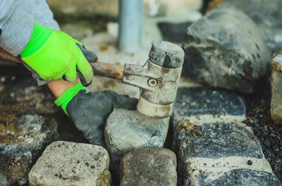 Close-up of hands working on rock