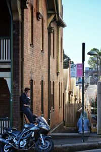 Side view of man in city against sky