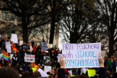 Close-up of information sign against trees