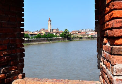 View of canal by building against clear sky