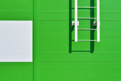 Closed green shutter and ladder