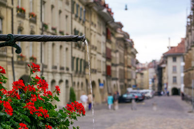 Low angle view of woman standing on street in city
