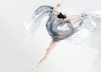 Woman dancing against white background