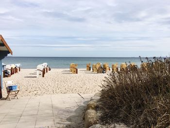 Beach against cloudy sky