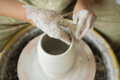 Woman making pottery on the wheel