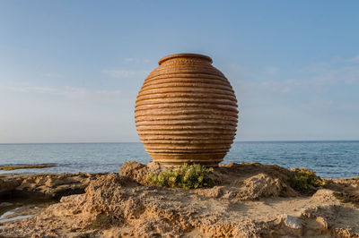 Scenic view of rocks on beach against sky