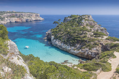 High angle view of rocks on sea shore against sky