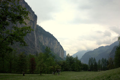 Scenic view of mountains against cloudy sky