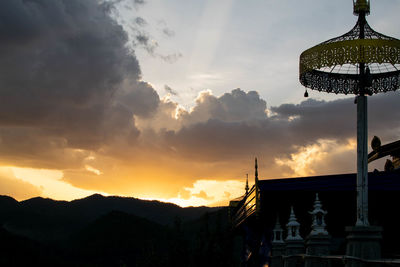 Low angle view of silhouette cross against sky during sunset