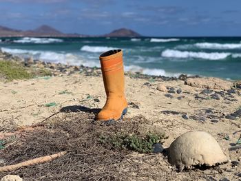 Close-up of sand on beach against sky