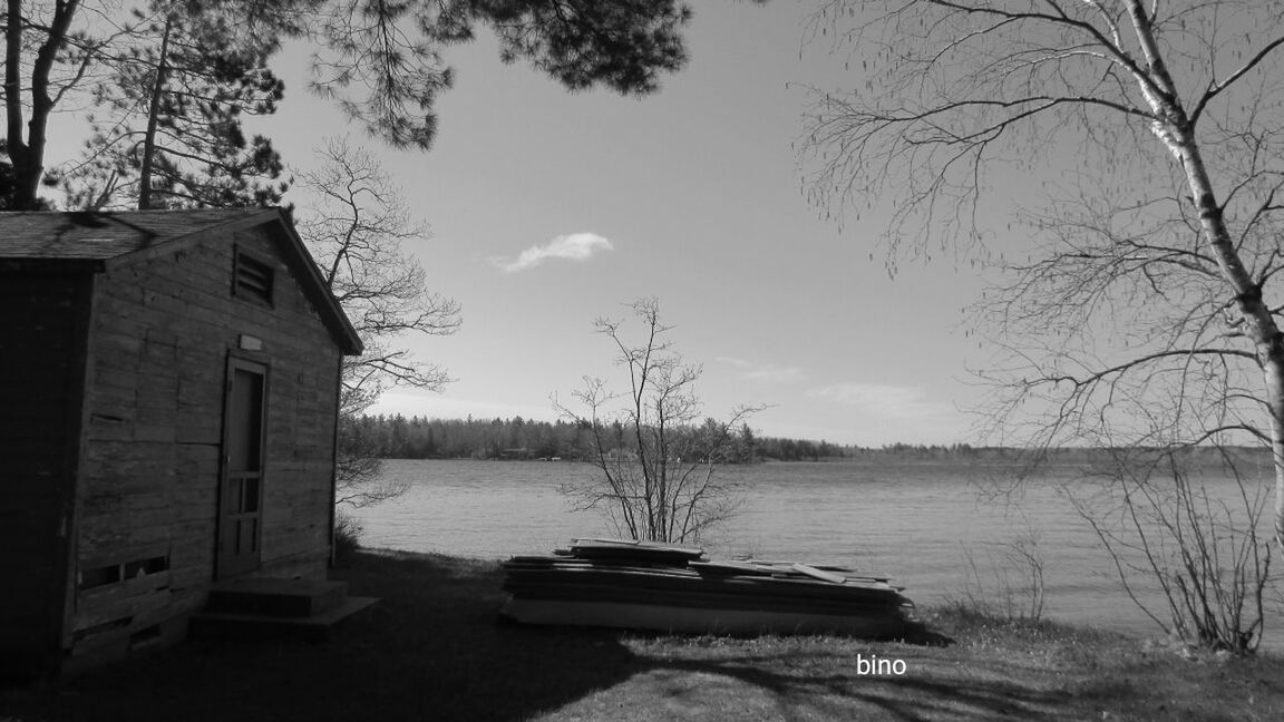 water, nature, tree, tranquility, no people, outdoors, day, tranquil scene, lake, bare tree, built structure, sky, beauty in nature, nautical vessel, building exterior, architecture, scenics, branch