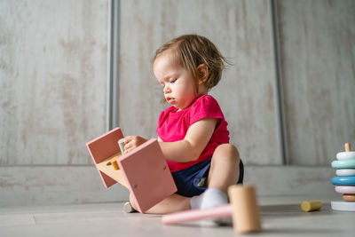 Portrait of young woman using digital tablet while sitting at home