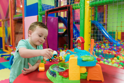 Cute boy playing with toys