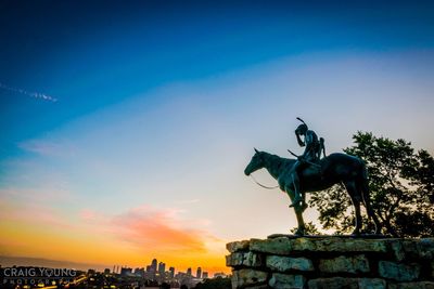 Statue of city against sky