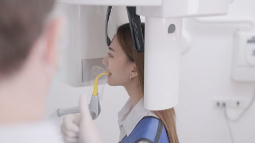 Dentist examining patient in laboratory