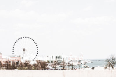 Ferris wheel at beach against clear sky