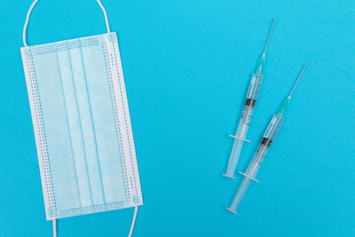 Close-up of blue colored pencils over white background