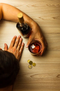 Stressed businessman holding a glass of cognac and ice