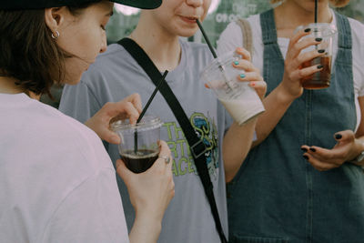 Low section of people holding ice cream