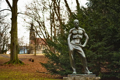 Statue against trees