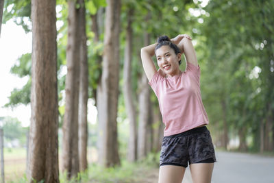 Smiling woman looking away while standing outdoors