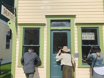 Rear view of man standing outside building