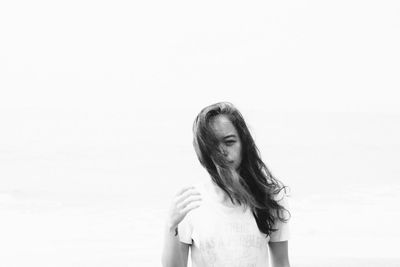 Portrait of mid adult woman standing against sky