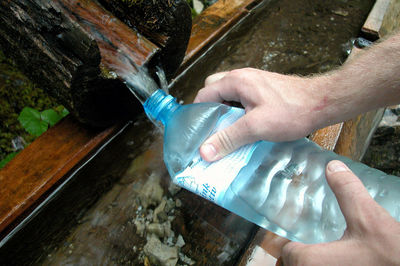 High angle view of man hand holding water