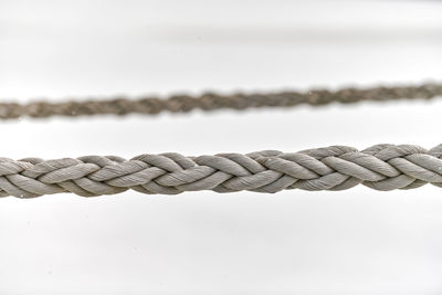 Sail ropes hanging from fishing ship or yacht, close up. detailed fragment of rope.