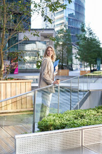 Portrait of young woman standing in park