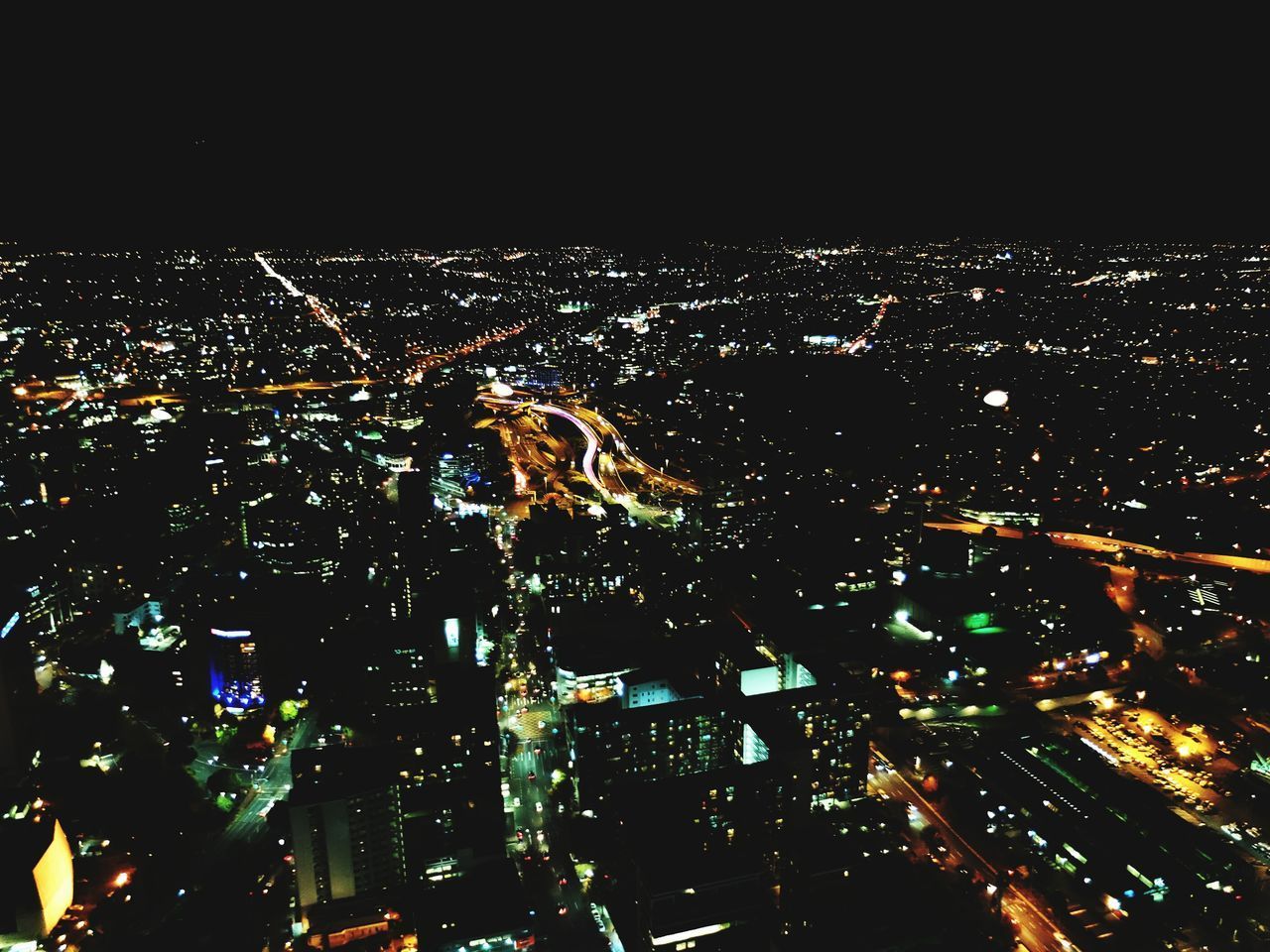 AERIAL VIEW OF ILLUMINATED CITY AT NIGHT