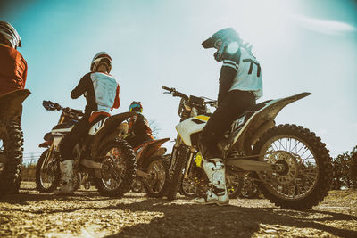 People riding motorcycle against sky