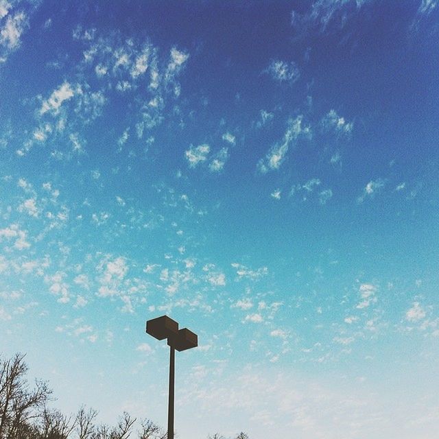 low angle view, street light, blue, sky, lighting equipment, pole, cloud - sky, tree, nature, outdoors, cloud, no people, day, tranquility, beauty in nature, high section, silhouette, sunlight, cloudy, lamp post