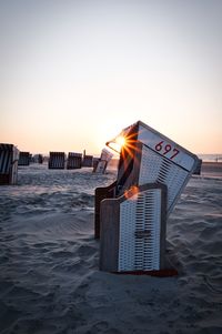 Man on beach against sky during sunset