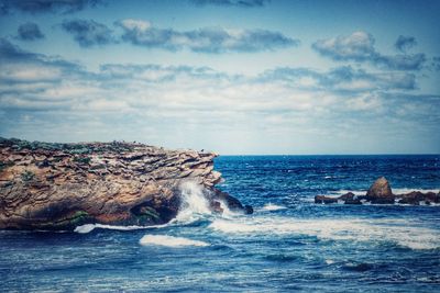 View of calm sea against cloudy sky