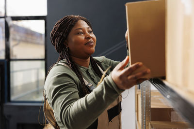 Side view of young woman reading book