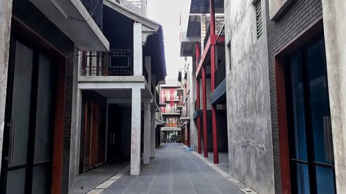 Narrow street amidst buildings in city