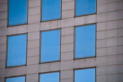 Low angle view of blue window on building