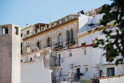 Low angle view of buildings in town against sky