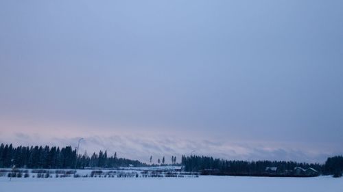 Scenic view of snow covered landscape against sky