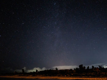 Scenic view of field against sky at night