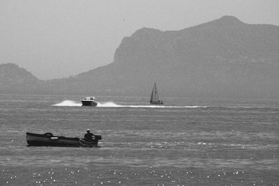 Sailboat sailing on sea against clear sky