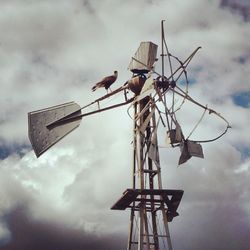 Low angle view of traditional windmill against clear sky