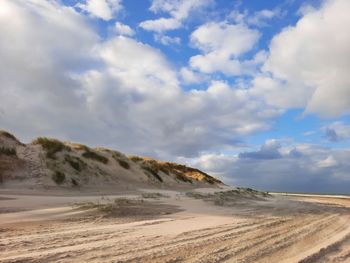 Scenic view of desert road against sky