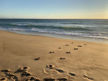 Scenic view of beach against clear sky