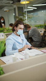 Businessman wearing mask working at office