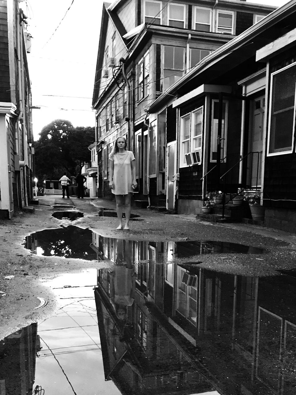 building exterior, architecture, built structure, city, building, street, water, reflection, wet, residential district, transportation, incidental people, day, rain, puddle, nature, car, mode of transportation, outdoors, rainy season