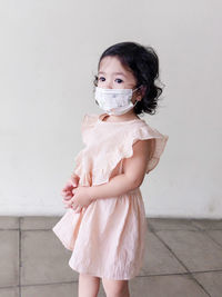 Kid girl wear mask with pink dress