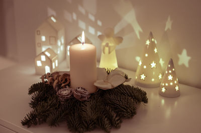 Close-up of illuminated candles on table