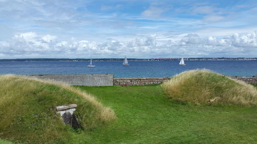 Scenic view of landscape against cloudy sky